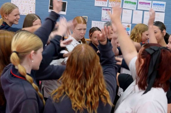 Class of teenage girls taking part in a school Kai-Fella workshop for mental heath 